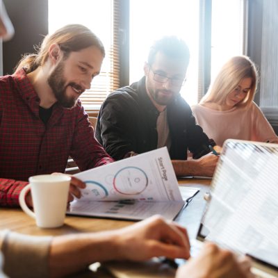 Image of young concentrated colleagues sitting in office and coworking.